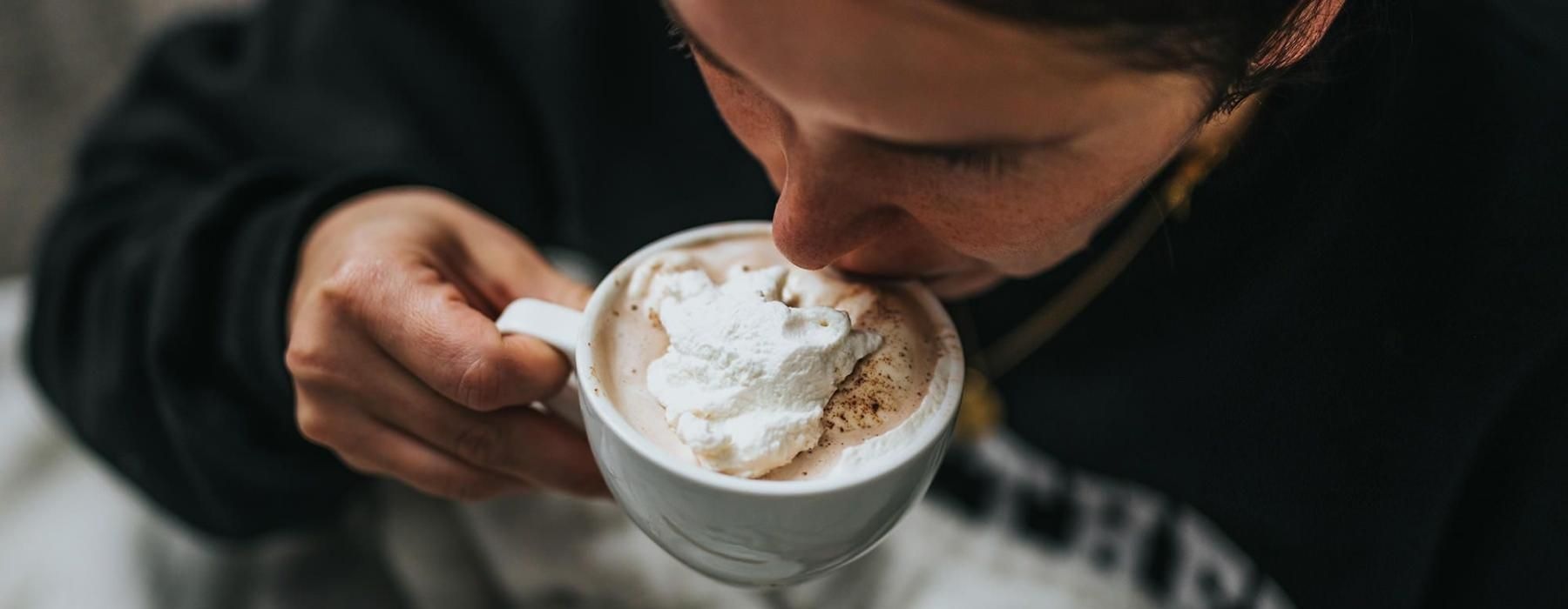 man sipping a hot beverage